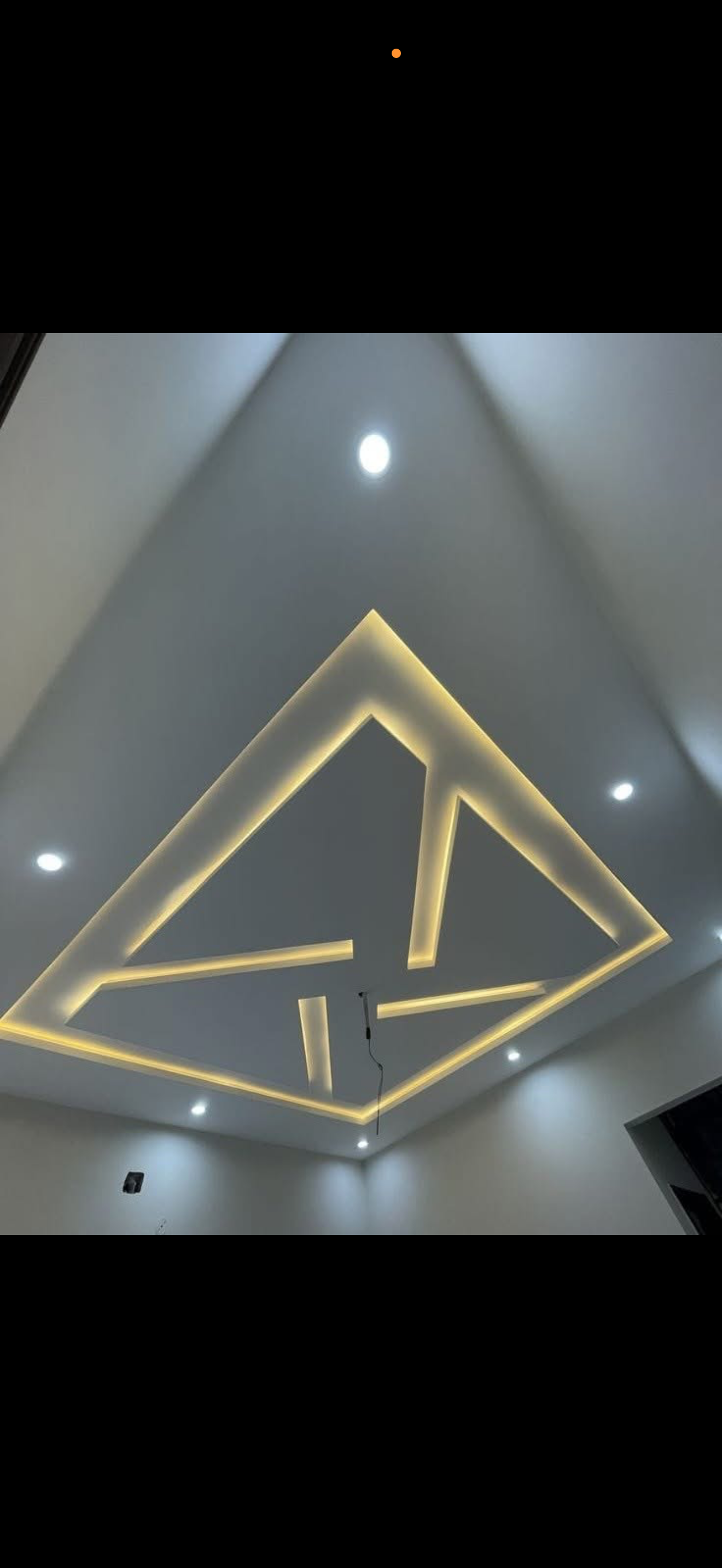 Abstract angular drywall ceiling design formed by warm LED strip lines and recessed spotlights