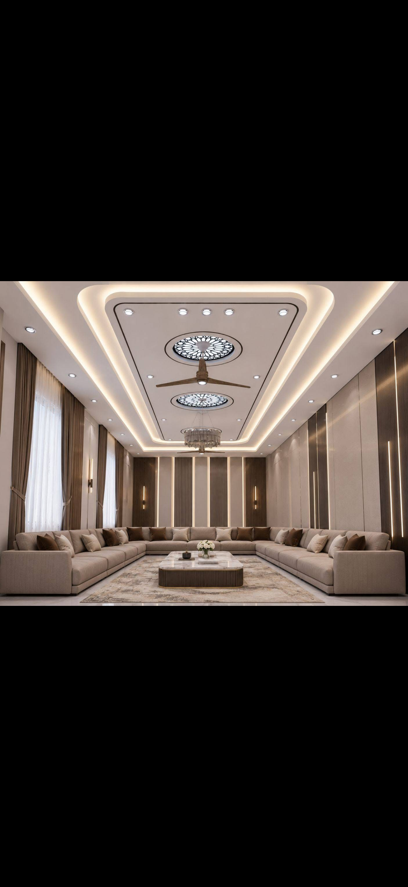 Luxury majlis with a layered drywall tray ceiling, cove lighting, decorative medallions and a chandelier above beige sectional seating